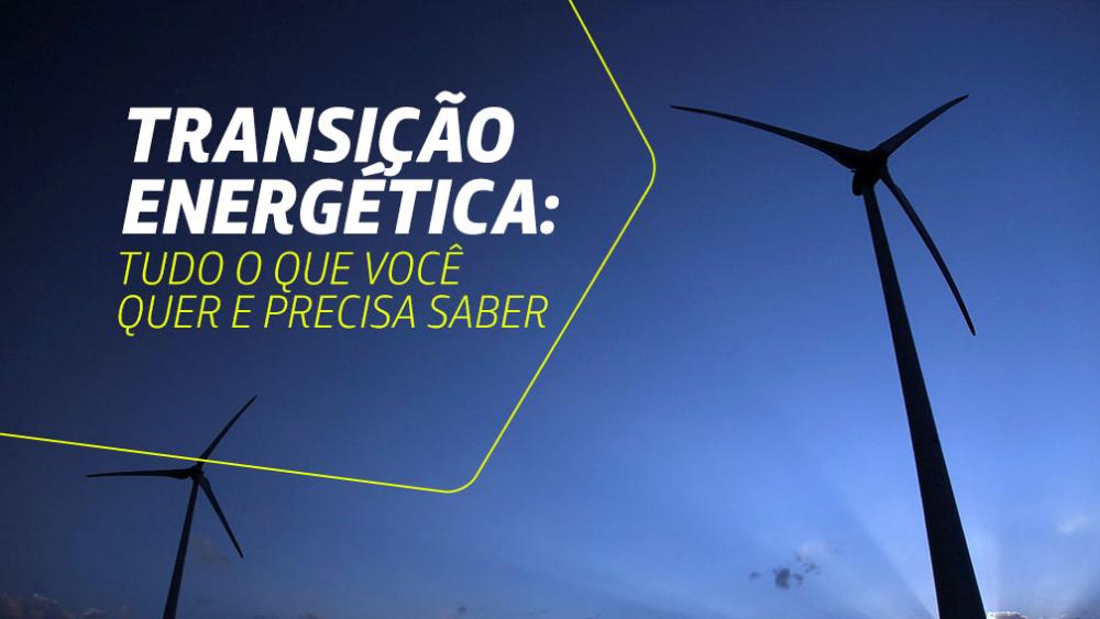 Aerogerados no nascer ou por do sol, com céu azul. A imagem tem a frase Transição Energética: Tudo que você precisa saber sobrescrita.